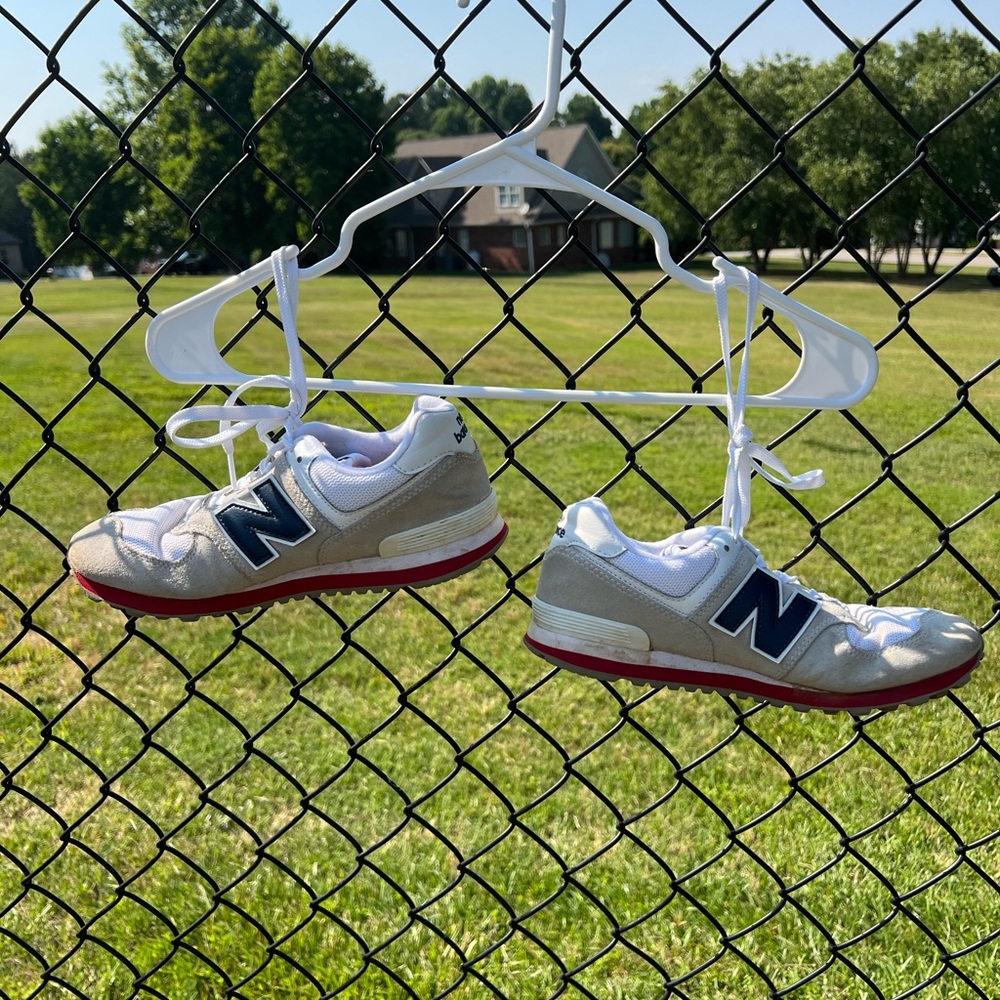 New Balance Classic 574 shoes in 5.5 men’s with colors tan, white, red, navy.